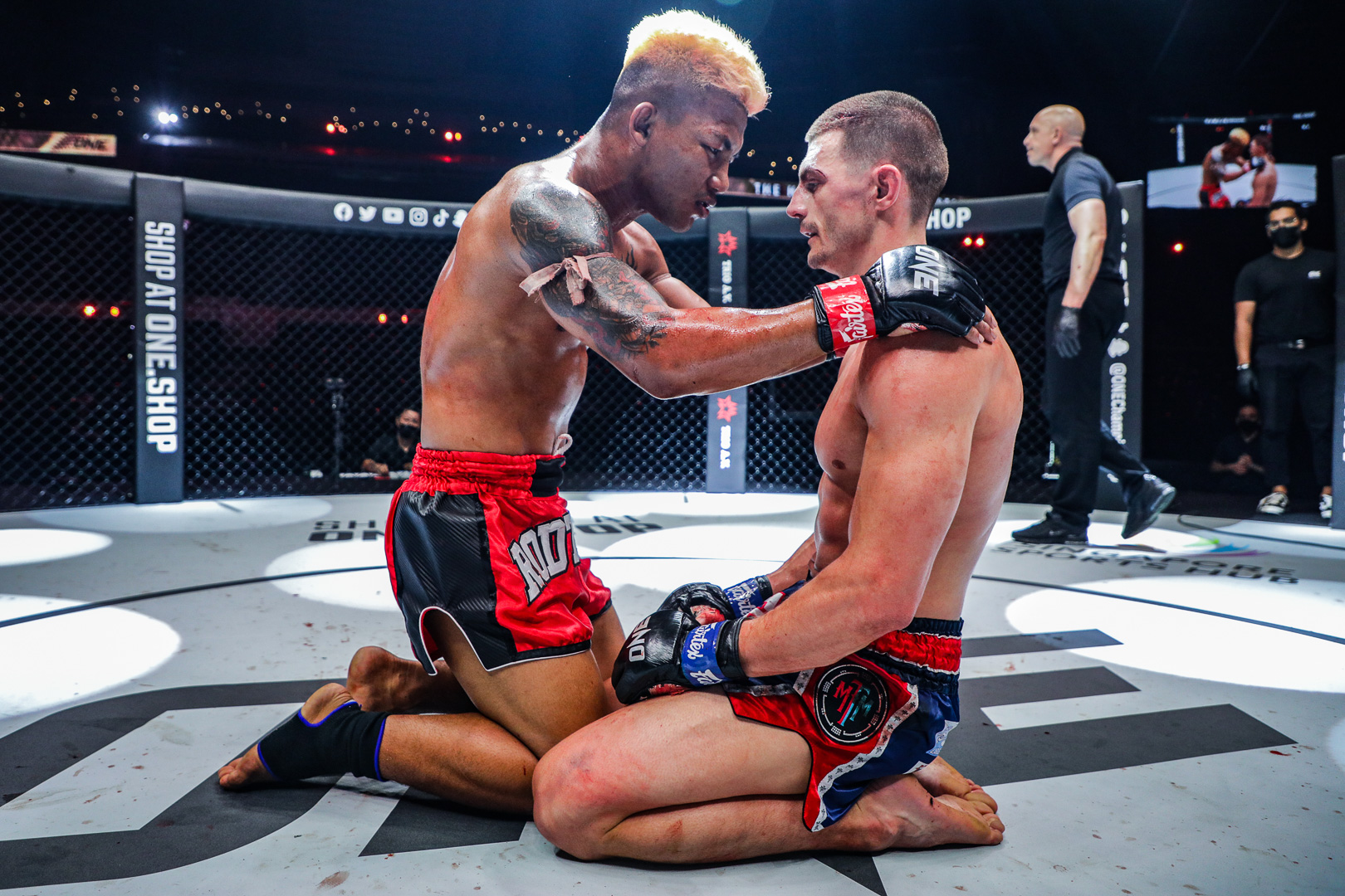 Rodtang Jitmuangnon and Jacob Smith kneel at ONE 157